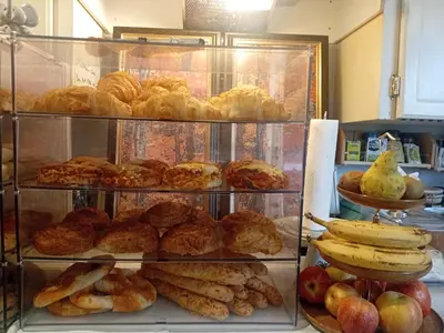 a display case filled with different types of pastries and fruit at Comfy Sleep In Fraser Valley With Breakfast in Abbotsford