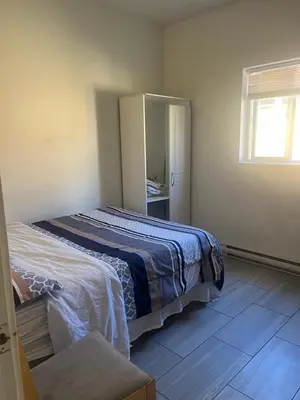 a bedroom with a bed and a mirror in it at three bedroom near uvic in Victoria