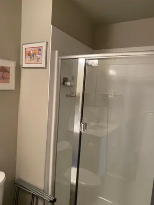 a shower with a glass door in a bathroom at Heart of Vernon in Vernon