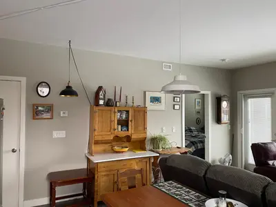 a living room with a couch and a table at Heart of Vernon in Vernon