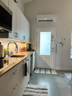 a kitchen with a sink and a white refrigerator at Getaway Carriage House - Great Location! Private! in Penticton