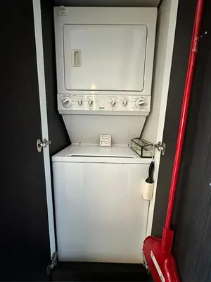 a white washer and dryer in a small room at Getaway Carriage House - Great Location! Private! in Penticton