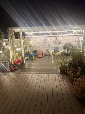 a patio with a deck with chairs and a playground at Peaceful House with Backyard in Langley