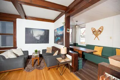 a living room with a couch and a table at Mountain View Retreat in the heart of Banff - Massive House Sleeps 23 in Banff