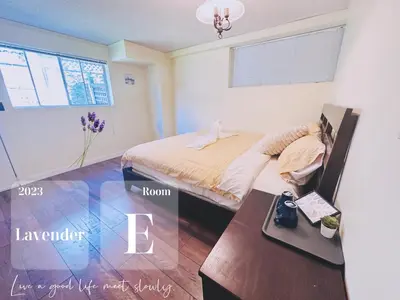 a bedroom with a bed and a table in it at Lavender house in Richmond