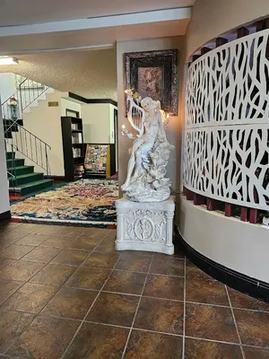 a statue of a woman on a pedestal in a hallway at Marina Hotel in Port Alberni