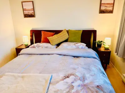 a bed with colorful pillows on it in a room at Departure view in Nanaimo