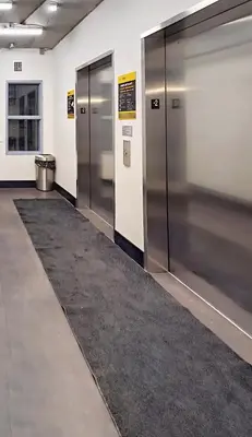 a row of lockers in a room with a rug at Family Stylish 1BR and Den Condo -Apartment with City View, Downtown, Balcony, Free Parking, In-Suite Laundry! in Calgary