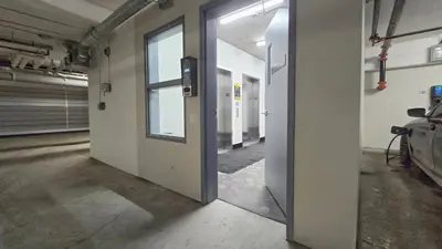 an empty room with a door in a building at Family Stylish 1BR and Den Condo -Apartment with City View, Downtown, Balcony, Free Parking, In-Suite Laundry! in Calgary
