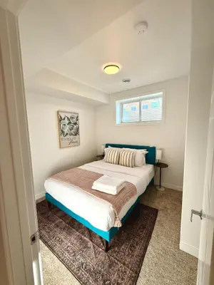 a bedroom with a bed and a window at IELS Homes in Edmonton