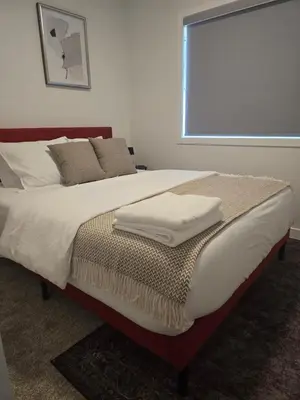 a bed with two towels sitting on top of it at IELS Homes in Edmonton