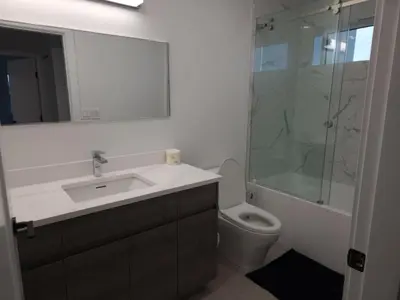 a bathroom with a sink and a shower and a toilet at Urban Elegance: Spacious 2-Bed Townhouse with Modern Charm in Vancouver