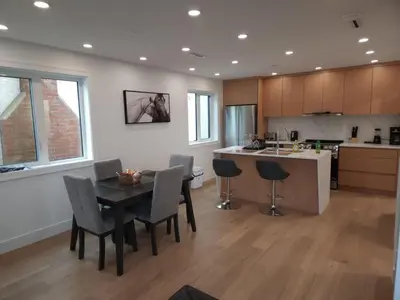 a kitchen and dining room with a table and chairs at Urban Elegance: Spacious 2-Bed Townhouse with Modern Charm in Vancouver