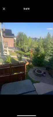 a window view of a backyard with a fire pit at Rooms for Hosting in Calgary