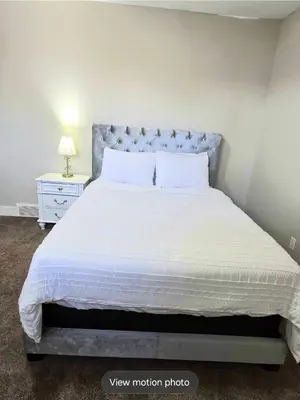 a bedroom with a large bed with a white bedspread at Golden Acreage Getaway 2 Bedroom in Balzac