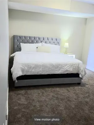 a bedroom with a large bed with a gray headboard at Golden Acreage Getaway 2 Bedroom in Balzac