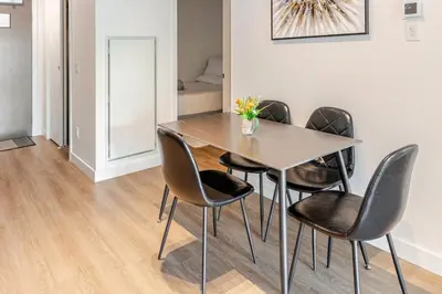 a dining room with a table and chairs at Scenic 2BR RiverView Suite in Downtown in Calgary