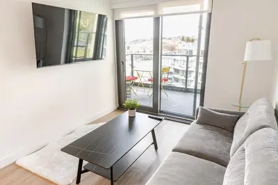 a living room with a couch and a table at Scenic 2BR RiverView Suite in Downtown in Calgary