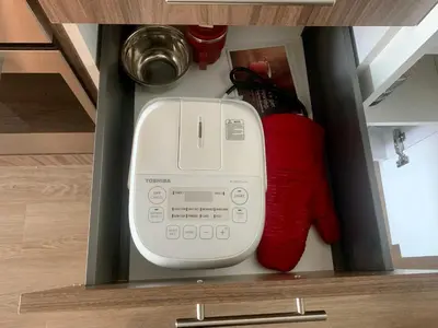 a computer in a drawer with a red sock at Scenic 2BR RiverView Suite in Downtown in Calgary