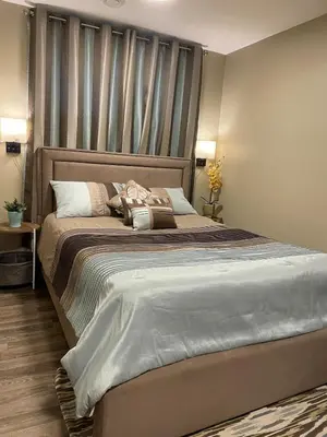 a bedroom with a large bed with a headboard at Beautifully Finished Basement Suite, Shared Entrance, SW Edmonton in Edmonton