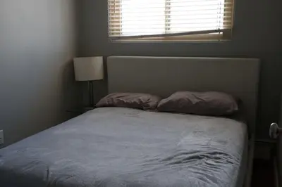 a bed in a bedroom with a window and a bed sidx sidx sidx at Elevated Living: 2-Bedroom Upper Apartment in Calgary