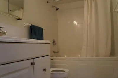 a bathroom with a tub and a toilet and a shower at Elevated Living: 2-Bedroom Upper Apartment in Calgary