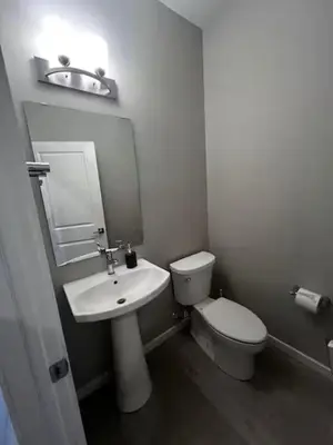 a white bathroom with a toilet and a sink at Bedroom private Bathroom in Upland in Edmonton
