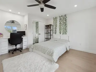 a bedroom with a bed and a desk and a computer at Spacious 4BR Langley Home in Langley