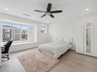 a bedroom with a bed and a ceiling fan at Spacious 4BR Langley Home in Langley