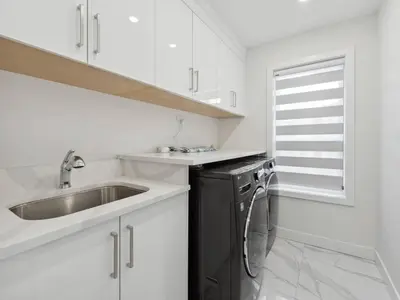 a white kitchen with a sink and a dishwasher at Spacious 4BR Langley Home in Langley