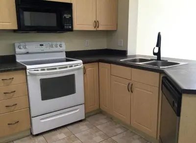 a kitchen with a white stove and a sink at ED Phonix