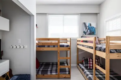 a room with two bunk beds and a window at Magical Lake View in Peachland