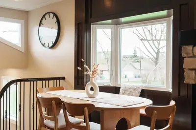 a dining room with a table and chairs and a window at 4 Bed Home Along River Near DT AC Hot Tub in Calgary