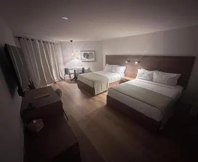 a hotel room with two beds and a table at Hotel 19 in Port Hardy
