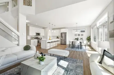 a white living room with a couch and a table at Magnificent Stylish Escape in Bélanger