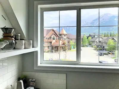 a kitchen window with a view of a street at Top Floor Mountain View Escape in Canmore