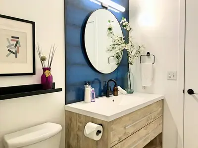 a bathroom with a sink and a mirror at Top Floor Mountain View Escape in Canmore