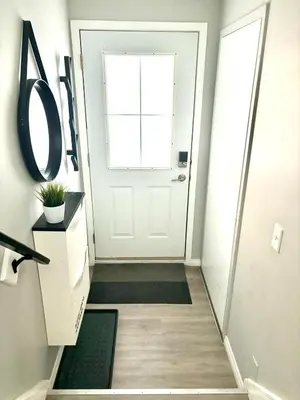 a hallway with a white door and a window at Top Floor Mountain View Escape in Canmore