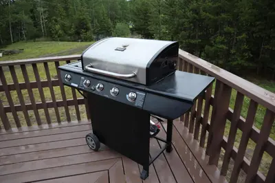 a grill sitting on top of a deck at Taylor Lake Resort BC in Lone Butte