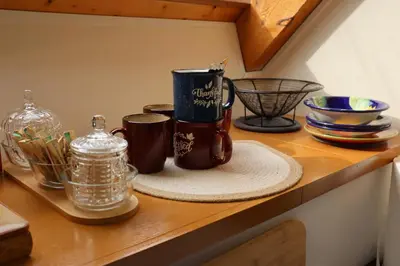 a shelf with two coffee cups and other dishes on it at Taylor Lake Resort BC in Lone Butte