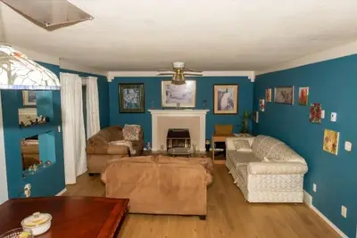 a living room with a couch and a fireplace at The Breakfast Getaway In Fraser Valley in Abbotsford