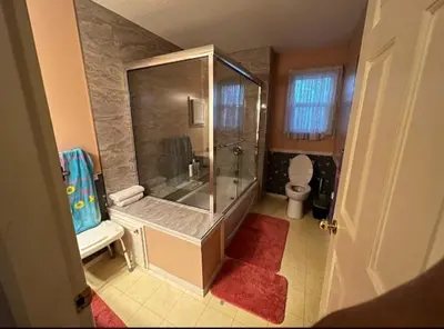 a bathroom with a glass shower and a toilet at The Breakfast Getaway In Fraser Valley in Abbotsford