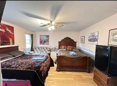 a bedroom with a bed and a ceiling fan at The Breakfast Getaway In Fraser Valley in Abbotsford