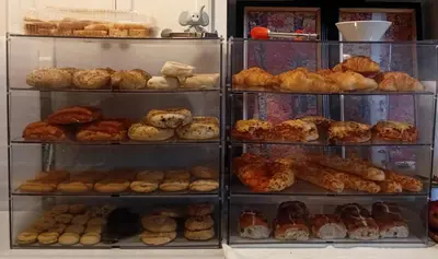 a display case filled with lots of different types of pastries at The Breakfast Getaway In Fraser Valley in Abbotsford
