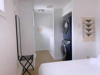 a laundry room with a washer and dryer in it at Canmore Top Floor Loft-Style Retreat in Canmore