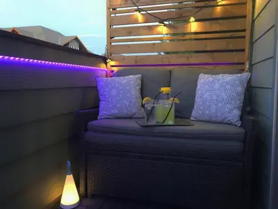 a wicker bench with a tray of drinks and lights at Canmore Top Floor Loft-Style Retreat in Canmore
