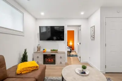 a living room with a couch and a fireplace at Meadowstone Suite 3BD 3 TVs Near Spruce Meadows in Calgary