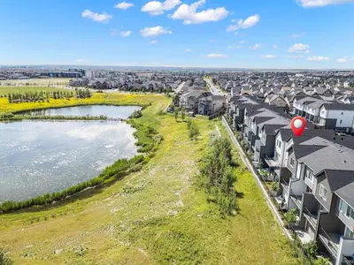 an aerial view of a city with houses and a river at Large Single Family 3 Bedroom House with Air Conditioner, Garage and Lake View in Calgary