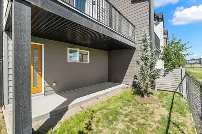 a home with a porch with a yellow door at Large Single Family 3 Bedroom House with Air Conditioner, Garage and Lake View in Calgary