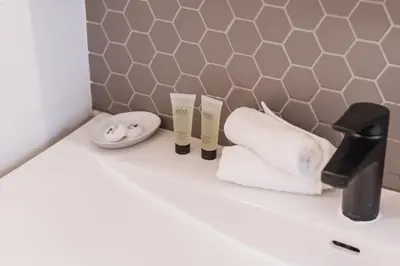 a bathroom counter with two towels and a sink at Play & Stay - Downtown Sleeps 10 in Edmonton